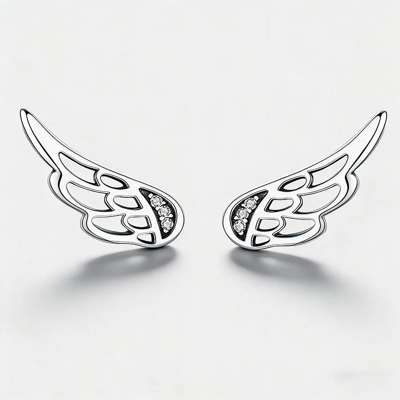 A pair of silver angel wing stud earrings with small clear crystal accents, displayed on a clean white background.